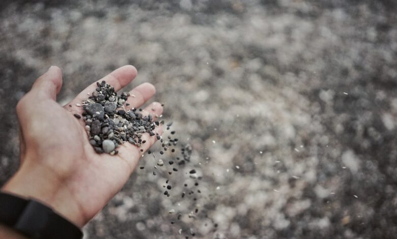 person pouring pebble