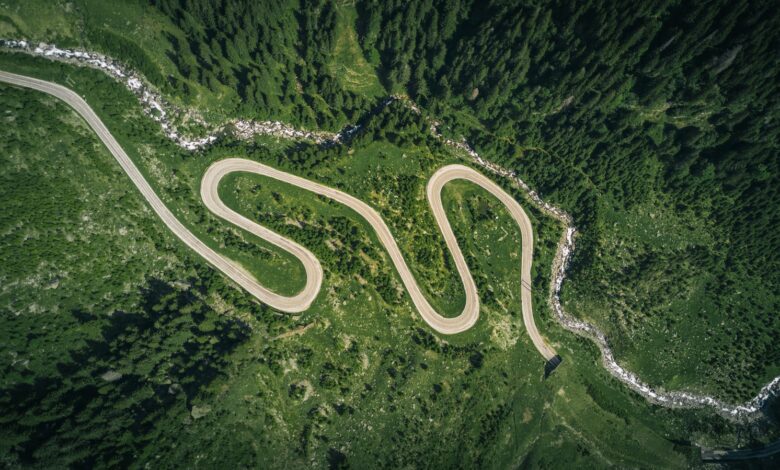 aerial view of asphalt road surrounded by trees